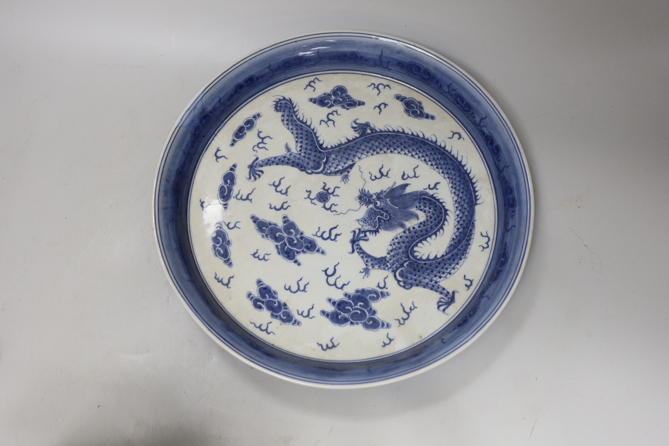 A Chinese blue and white dish, a famille rose bowl, a Canton enamel box and cover and a gilt decorated lacquer box and cover